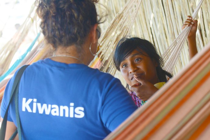 A girl from the Wayuu indigenous etnia talks with a member of Kiwanis Foundation during a Christmas event where members of Kiwanis Foundation gave away gifts to Wayuu kids at the Manhanaim Rancheria in Cabo de la Vela, Guajira department, Colombia, on December 23, 2017. Photo by Joaquin Sarmiento